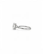 Side profile of a white gold and diamond engagement ring with a hidden halo on a white background 