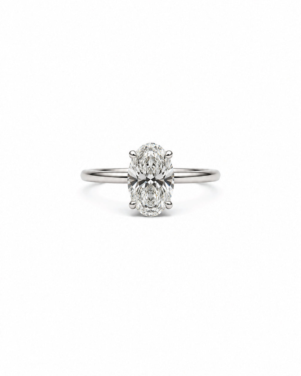 An oval-cut diamond engagement ring with a white gold band, centered on a plain white background.