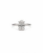 An oval-cut diamond engagement ring with a white gold band, centered on a plain white background.