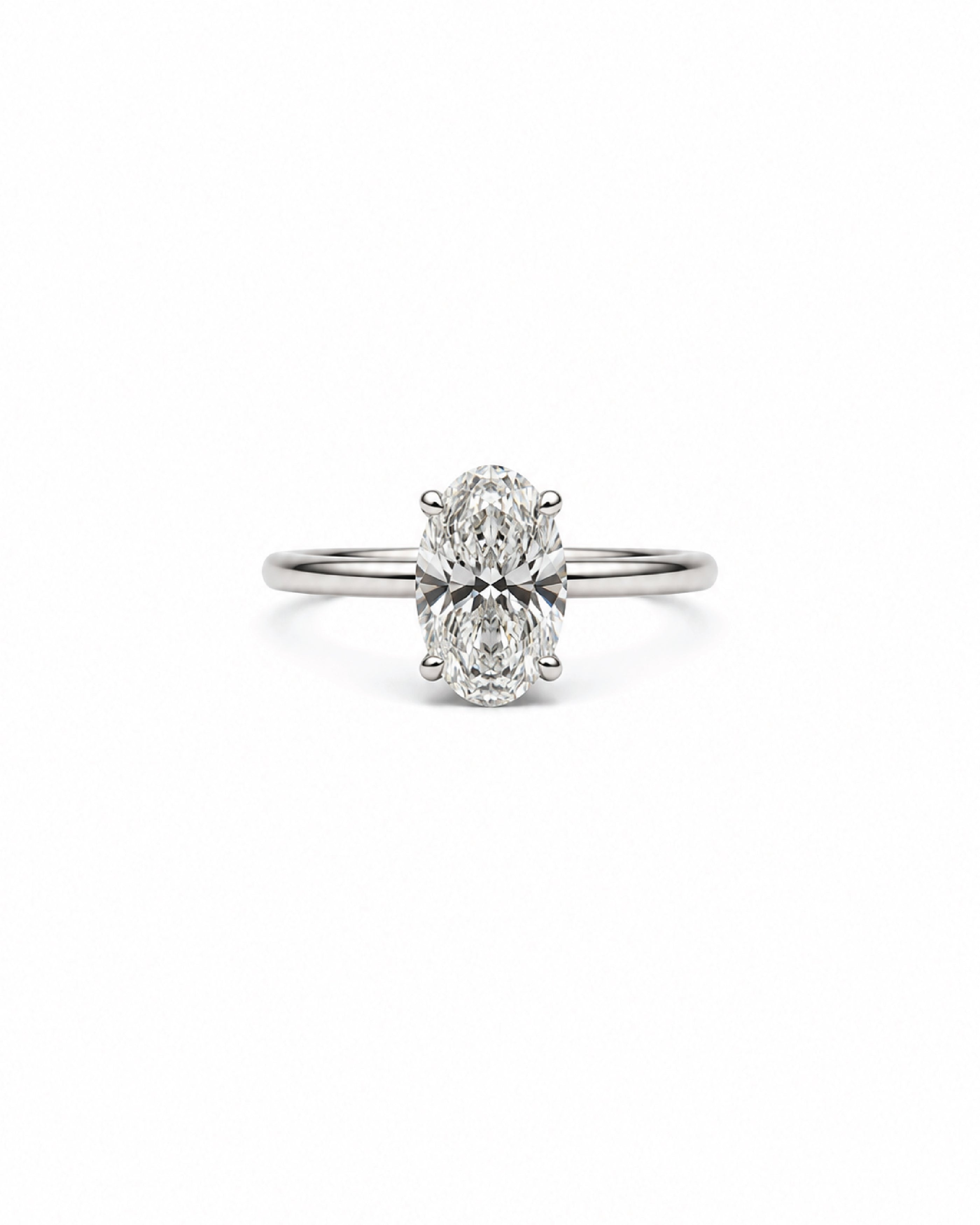 An oval-cut diamond engagement ring with a white gold band, centered on a plain white background.