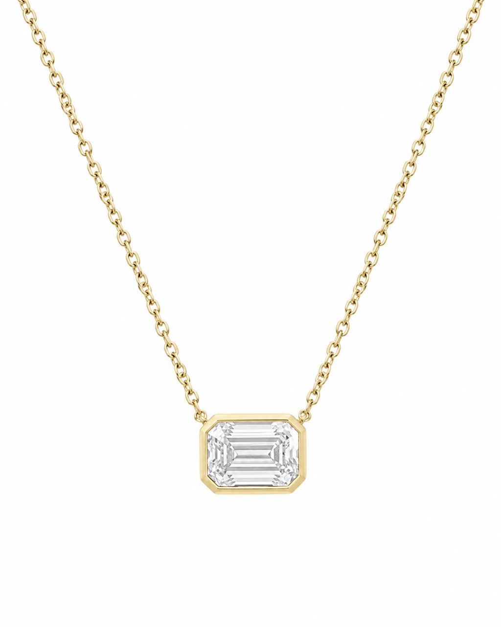 A delicate yellow gold chain necklace featuring a rectangular bezel-set clear emerald-cut gemstone pendant, shown against a plain white background.
