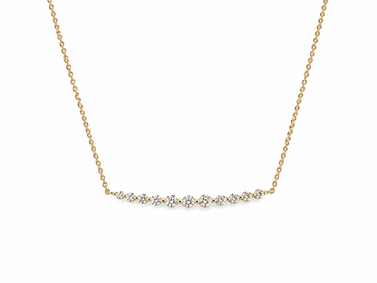 Gold necklace with small diamonds on a white background