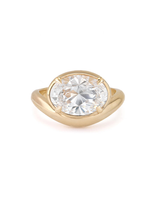 An 18K yellow gold engagement ring with a east-west oval diamond setting.