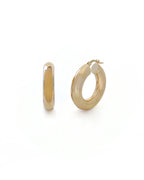 Gold hoop earrings on a white background