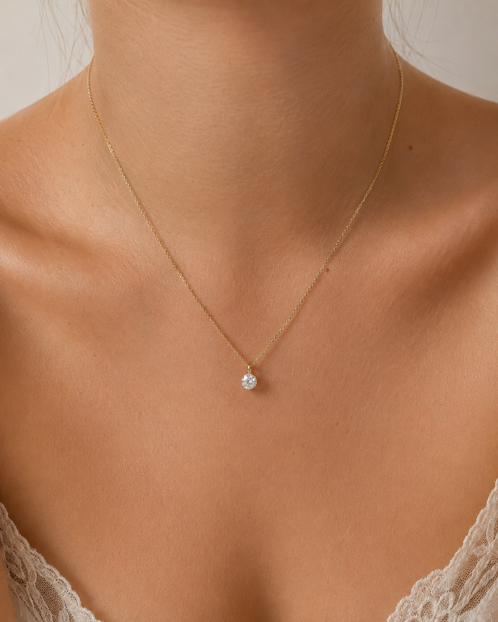 Diamond solitaire pendant worn on model, close-up