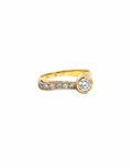 Vintage 14K gold ring with an off-set bezel round diamond