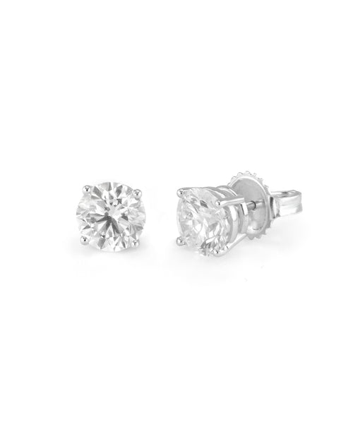 Pair of diamond stud earrings on a white background