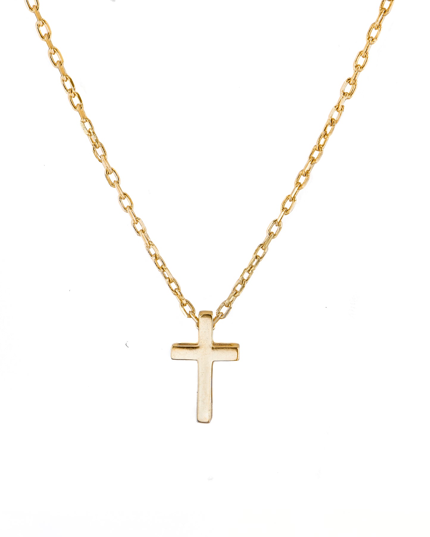 Gold cross necklace on a white background