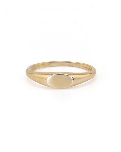 A 14K yellow gold signet ring with a plain band and a customizable engraving surface.
