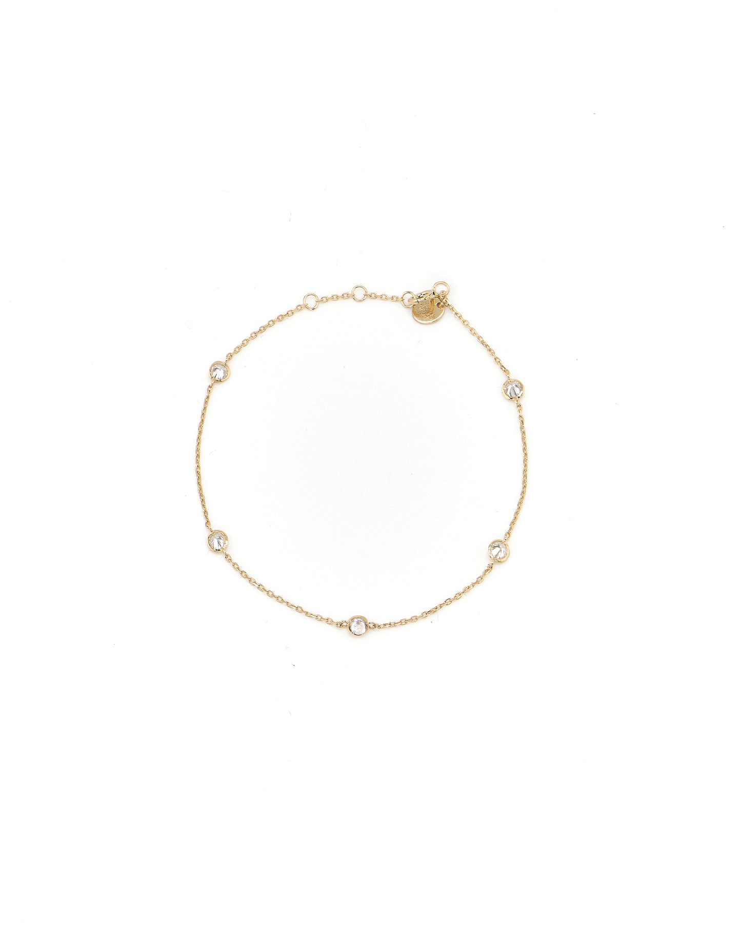 Gold bracelet with small diamonds on a white background
