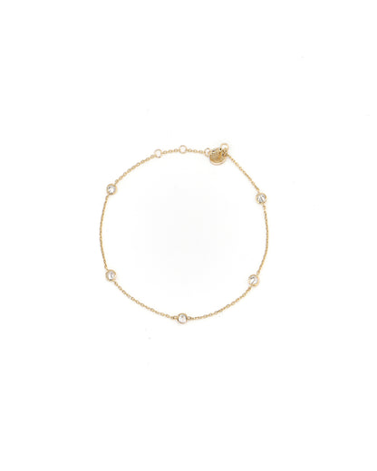 Gold bracelet with small diamonds on a white background