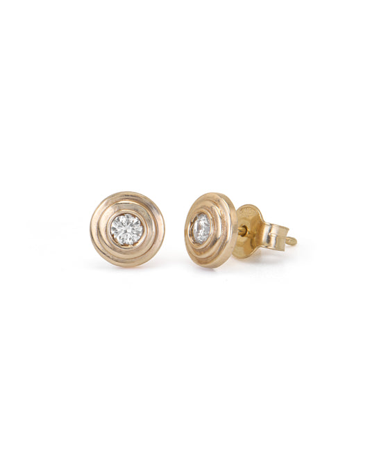 Pair of gold earrings with diamond studs on a white background