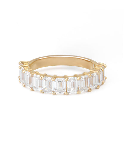 A gold band featuring a series of emerald cut diamonds set closely together.