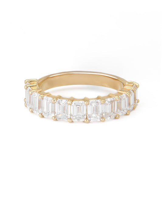 A gold band featuring a series of emerald cut diamonds set closely together.