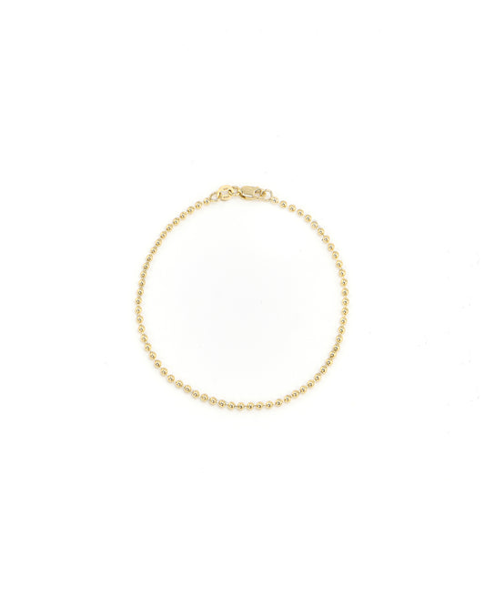 Gold bracelet on a white background