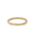 A gold bead stacker ring with a smooth finish and polished surface, displayed against a white background