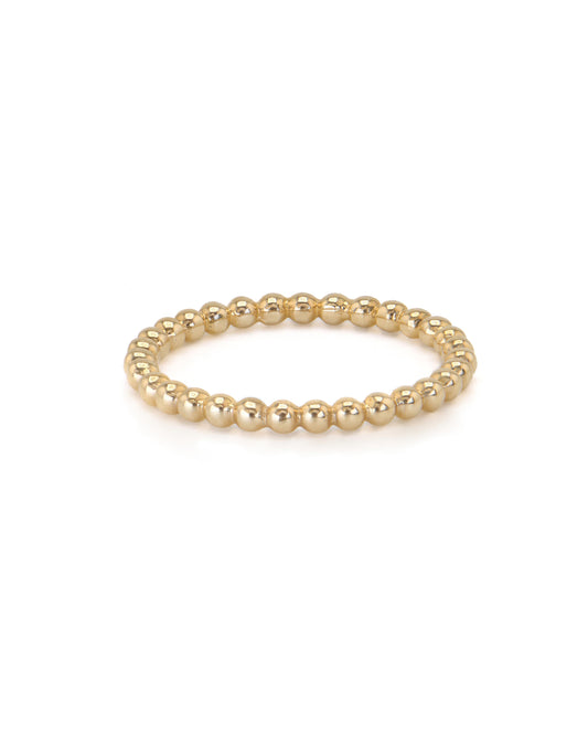 A gold bead stacker ring with a smooth finish and polished surface, displayed against a white background