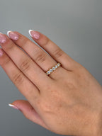 Bezel-set diamond band worn on hand, close-up
