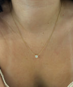 Bezel diamond necklace worn on model, close-up