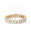 A gold eternity ring with alternating baguette and round-cut diamonds.