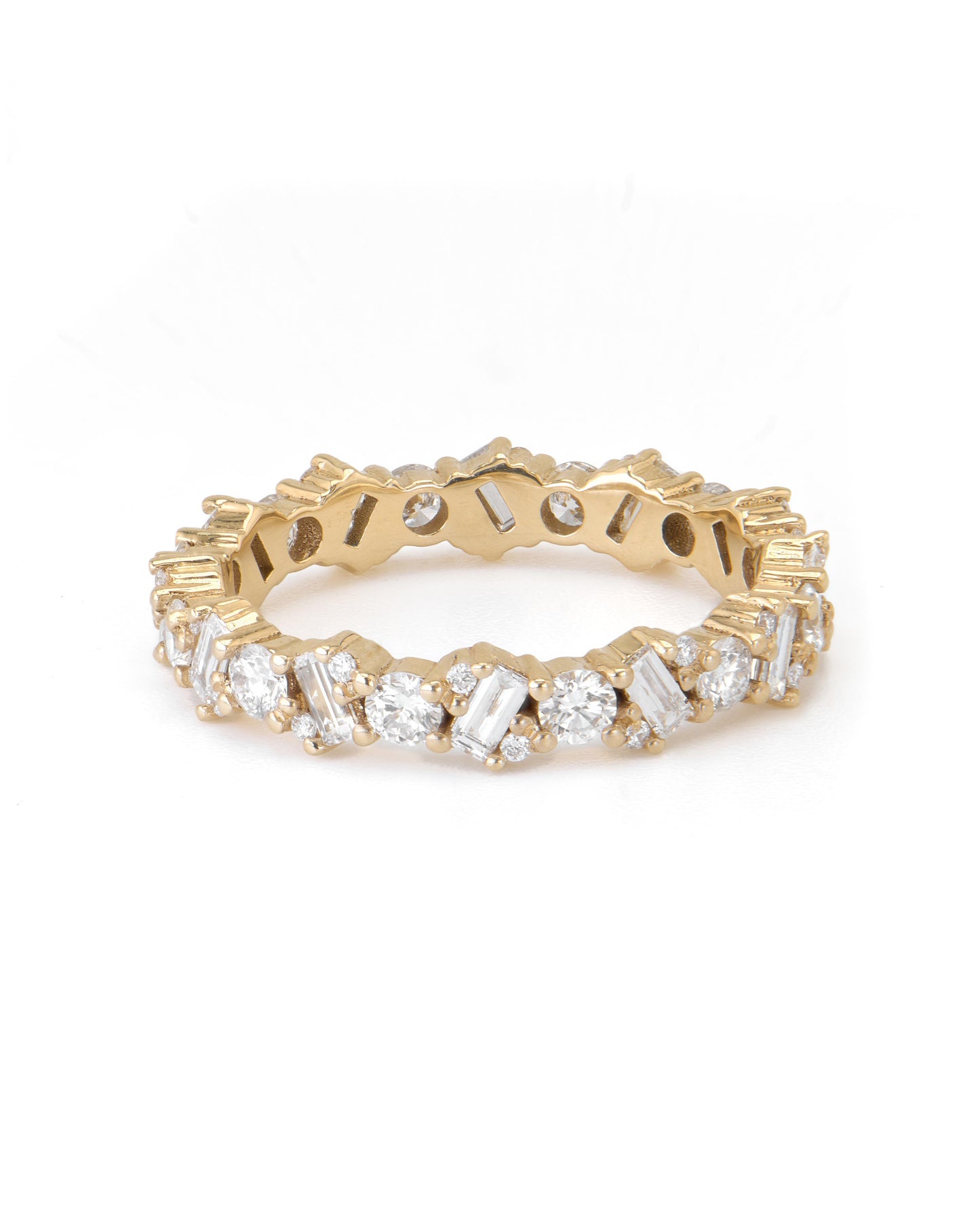 A gold eternity ring with alternating baguette and round-cut diamonds.
