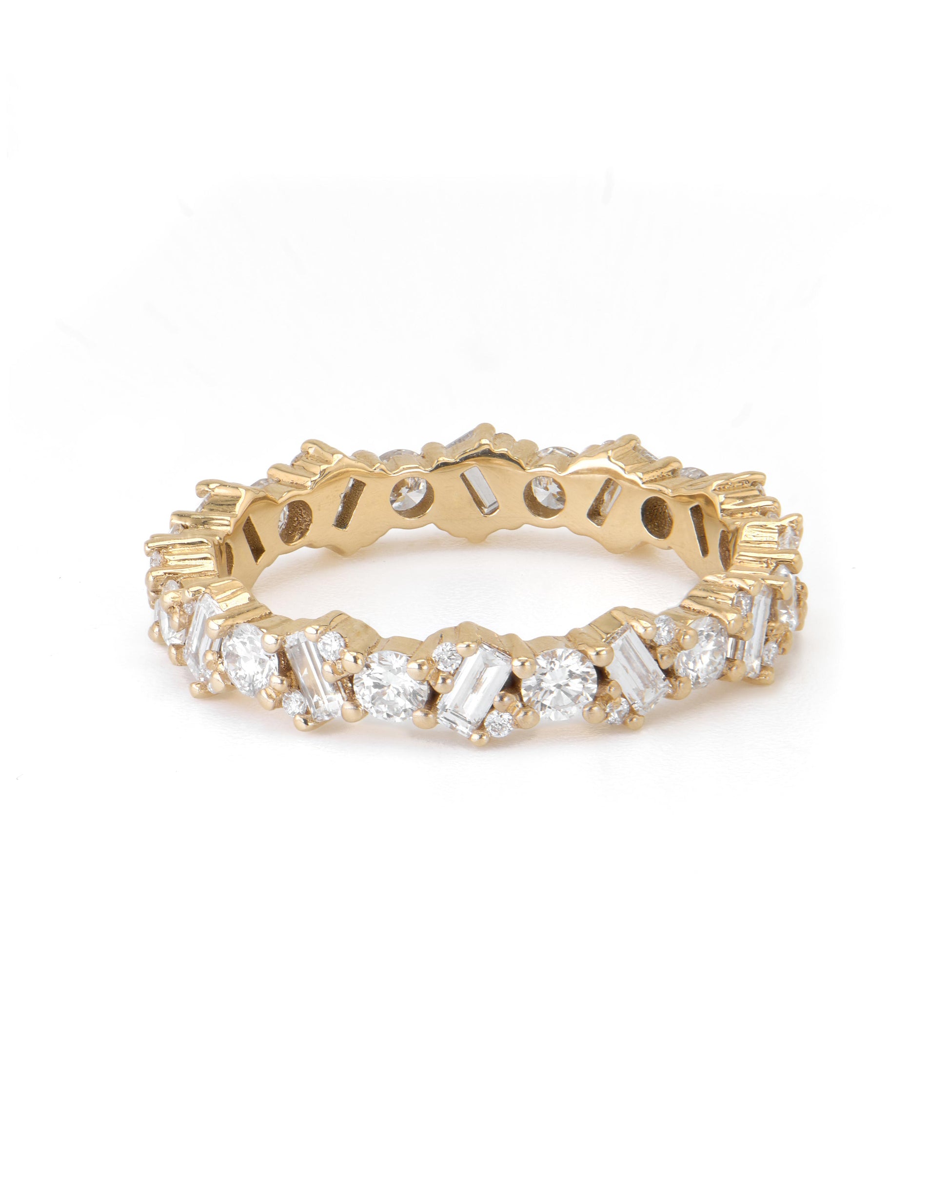 A gold eternity ring with alternating baguette and round-cut diamonds.