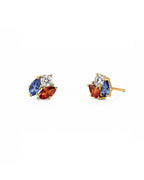 A pair of gold stud earrings featuring marquise-cut blue and orange-red gemstones with a small round diamond center stone, shown on a plain white background.