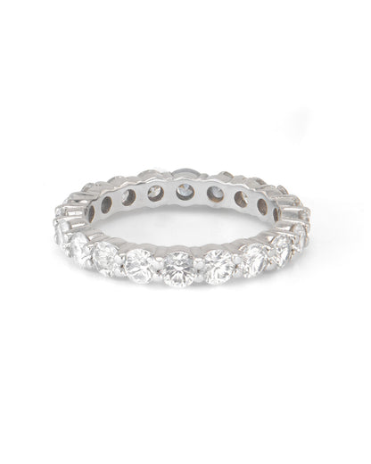 A round diamond shared prong band ring with multiple stones, displayed against a white background.