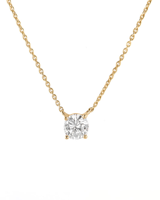 Gold necklace with a diamond pendant on a white background