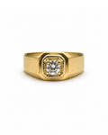 A yellow gold signet ring with a prominent octagonal bezel setting holding a round brilliant-cut diamond, shown against a plain white background.