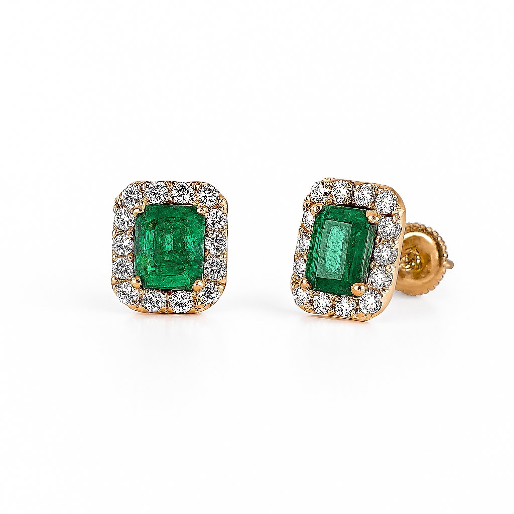Pair of emerald and diamond stud earrings on a white background