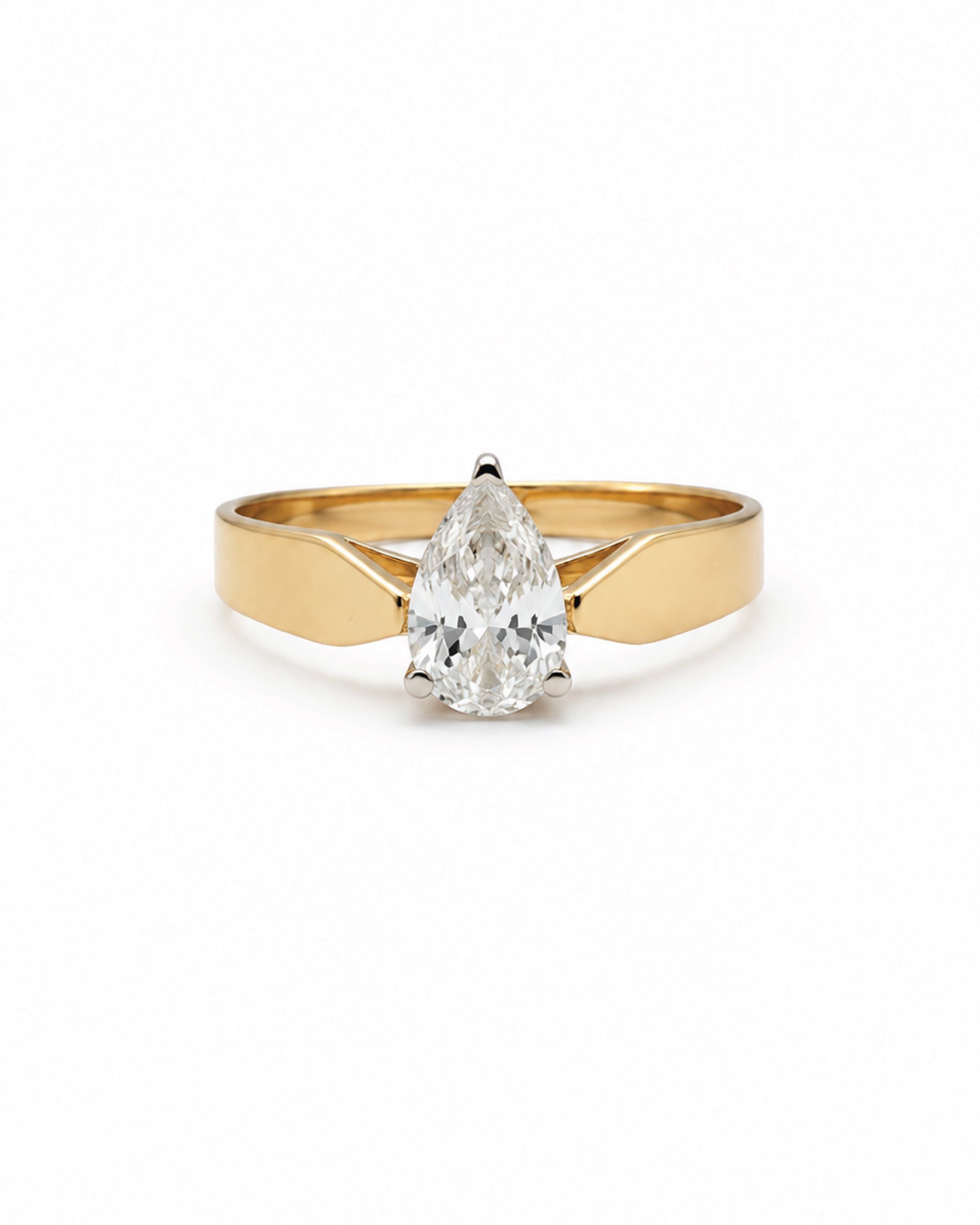 A yellow gold ring featuring a pear-cut diamond in a prong setting, shown against a plain white background.