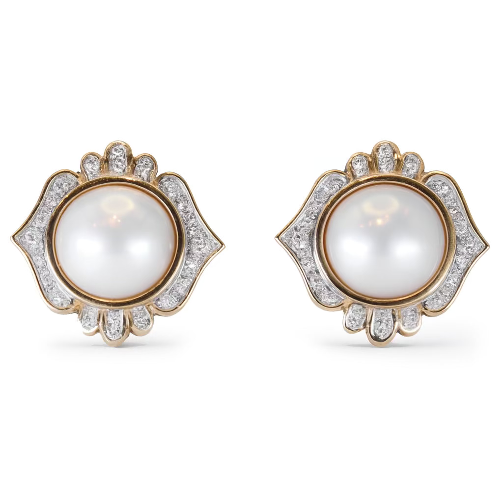 Pair of earrings with pearls and gold accents on a white background