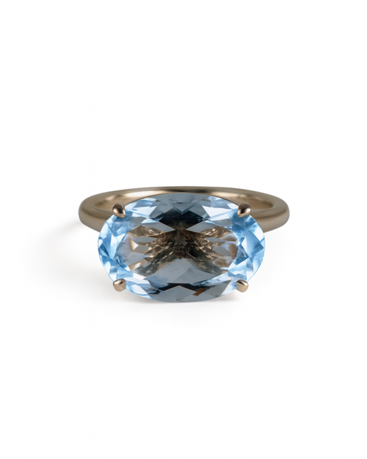 Ring with a blue gemstone on a white background