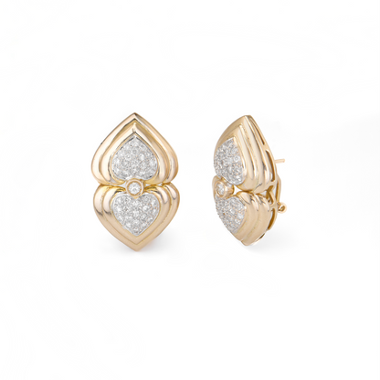 Gold earrings with heart design on a white background